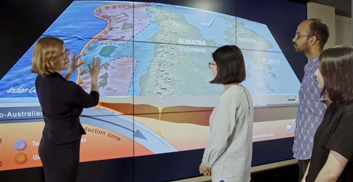 Associate Professor Emma Hill, left, explains how tectonic movements near Sumatra can cause land height changes in the region. For a detailed explanation of the process, view the Changing Ocean Asia episode (Source: Screengrab from Changing Ocean Asia)
