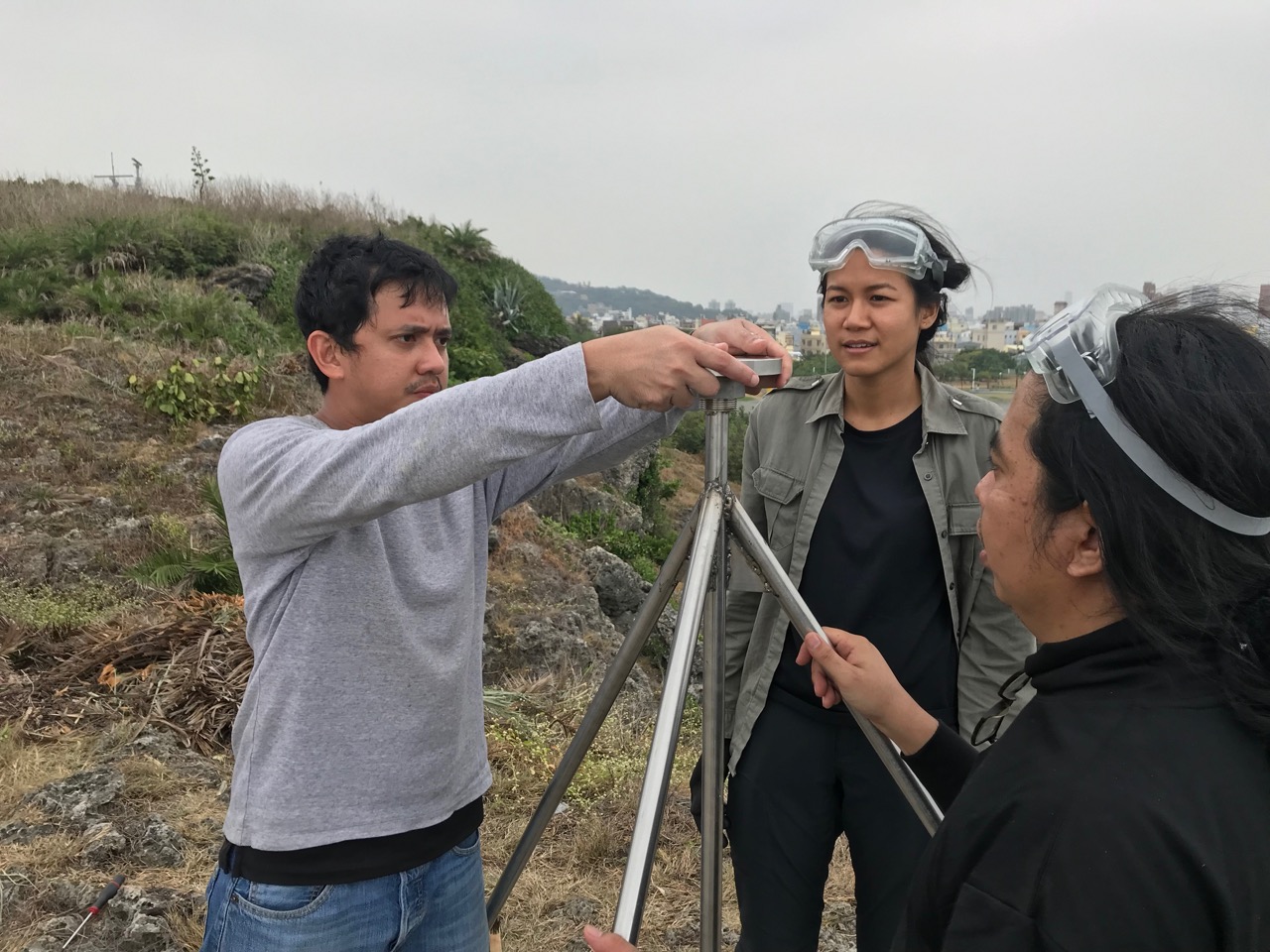Field engineers from CGO setting up the GPS antenna base plate of a coastal GPS station in Kaohsiung, Taiwan, for a sea-level rise research project (Source: Leong Choong Yew/Earth Observatory of Singapore)
