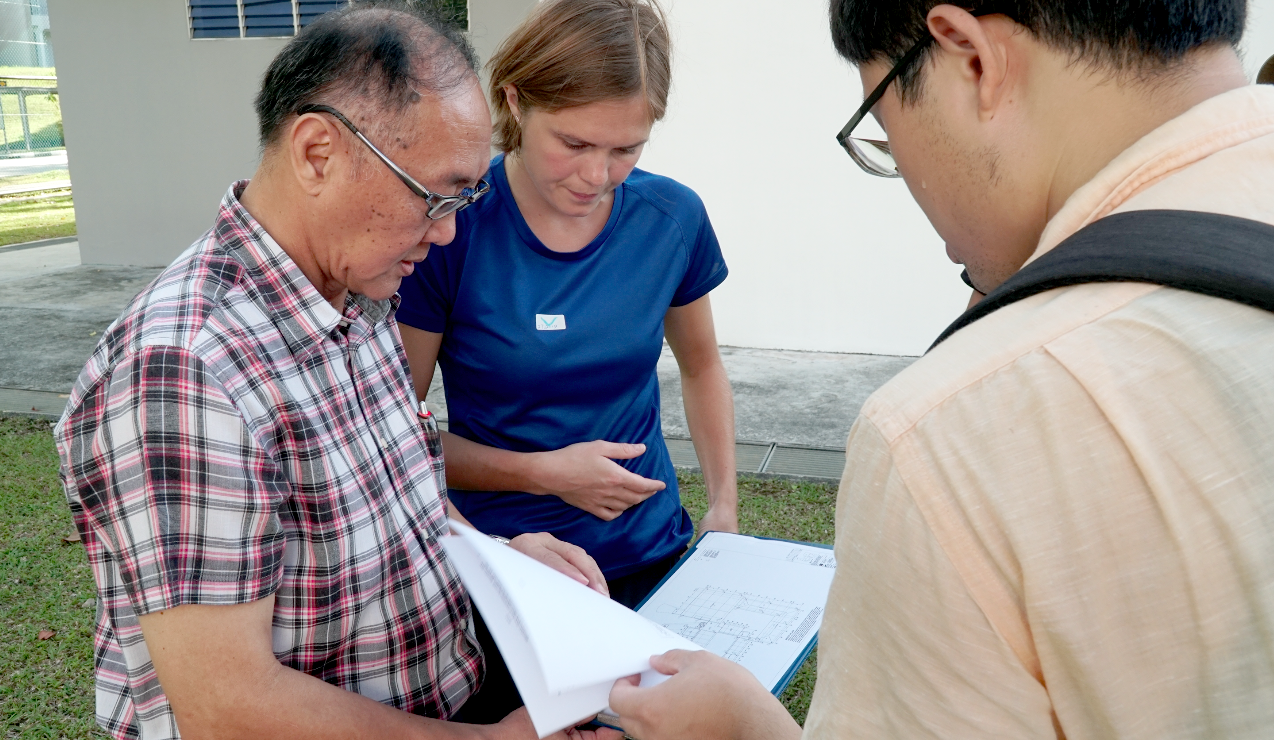 EOS scientists Dr Karen Lythgoe (centre) and Mr Zeng Hongyu (right) discuss with the school manager of Bukit View Secondary School the best place to install the seismometer (Source: Antoinette Jade/Earth Observatory of Singapore)