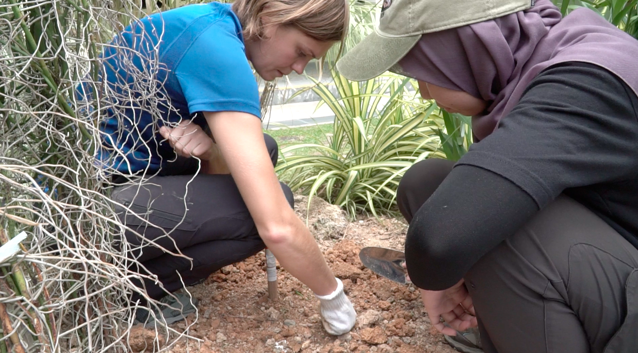 Dr Karen Lythgoe (left) and Ms Wardah Shafiqah Binti Mohammad Fadil hard at work installing a seismometer in a school (Source: Antoinette Jade/Earth Observatory of Singapore) 