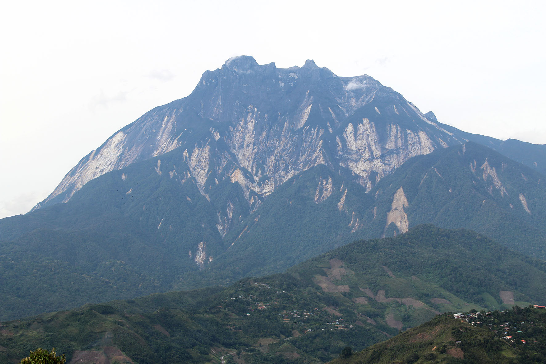 View of Mount Kinabalu from Pekan Nabalu, a small town at which tourists visiting the mountain would stop. Trails of rock debris can be seen on the slopes of the mountain where landslides had occurred (Source: Yvonne Soon) View of Mount Kinabalu from Pekan Nabalu, a small town at which tourists visiting the mountain would stop. Trails of rock debris can be seen on the slopes of the mountain where landslides had occurred (Source: Yvonne Soon)