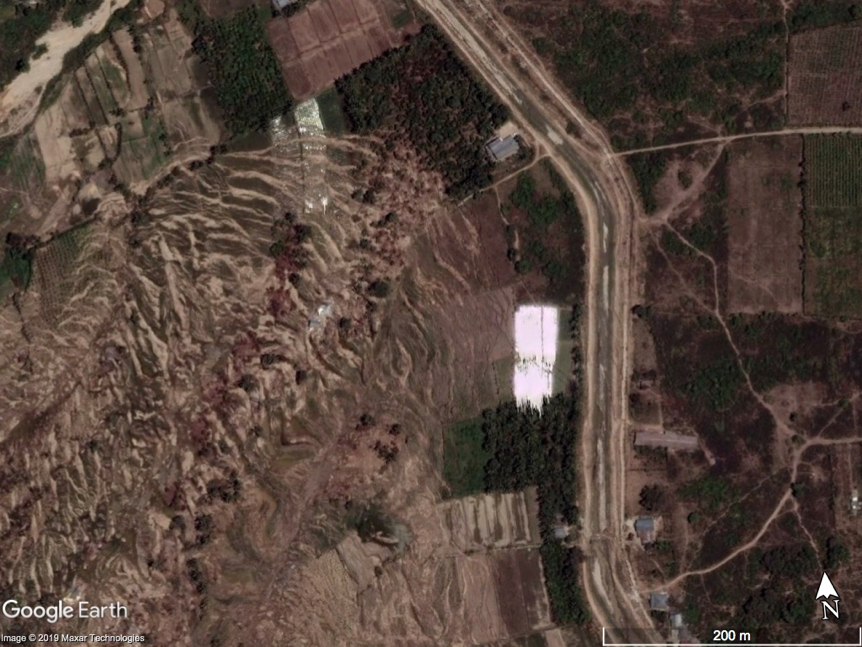 Satellite view of the same area two days after the earthquake and landslides. Lateral spreading occurred only below the aqueduct, carrying material down slope to the west (left) (Source: Google Earth)