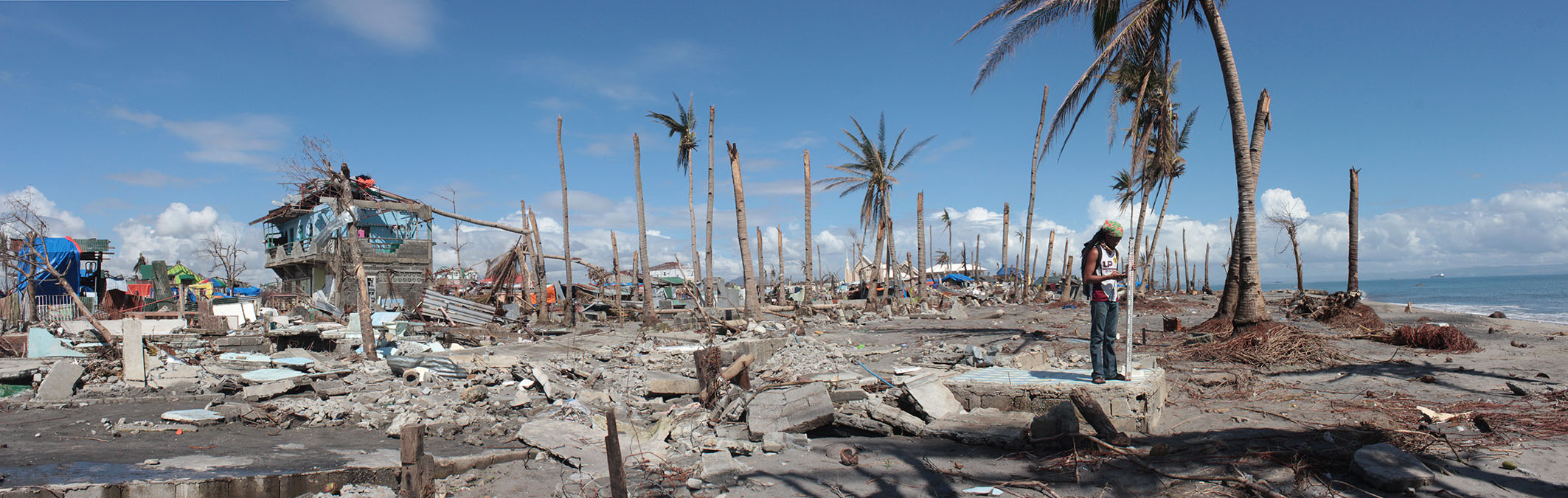 The aftermath of Typhoon Haiyan, which devastated the Philippines in November 2013. The eroded roots, the sand amongst the rubble, and the snapped trunks of the palms give clues to the scientists about the dynamics of the storm surge associated with the typhoon (Source: Lea Soria/ Earth Observatory of Singapore)